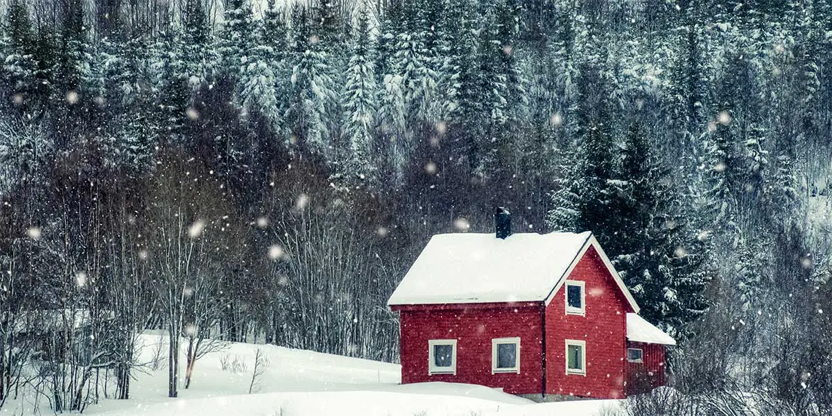 snow fall over red vacational rental on north shore